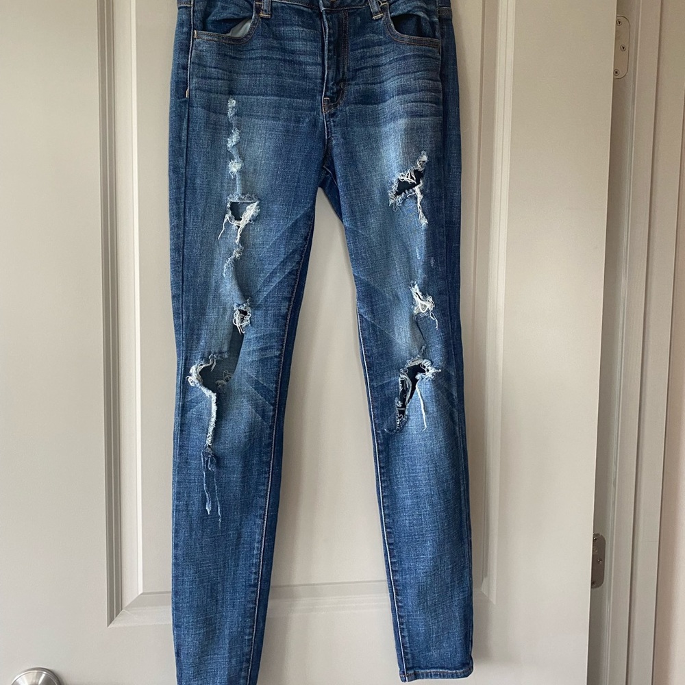 Dark blue jeans with holes